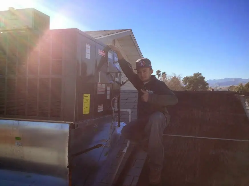 HVAC technician performing HVAC Inspection on a rooftop unit in Texarkana